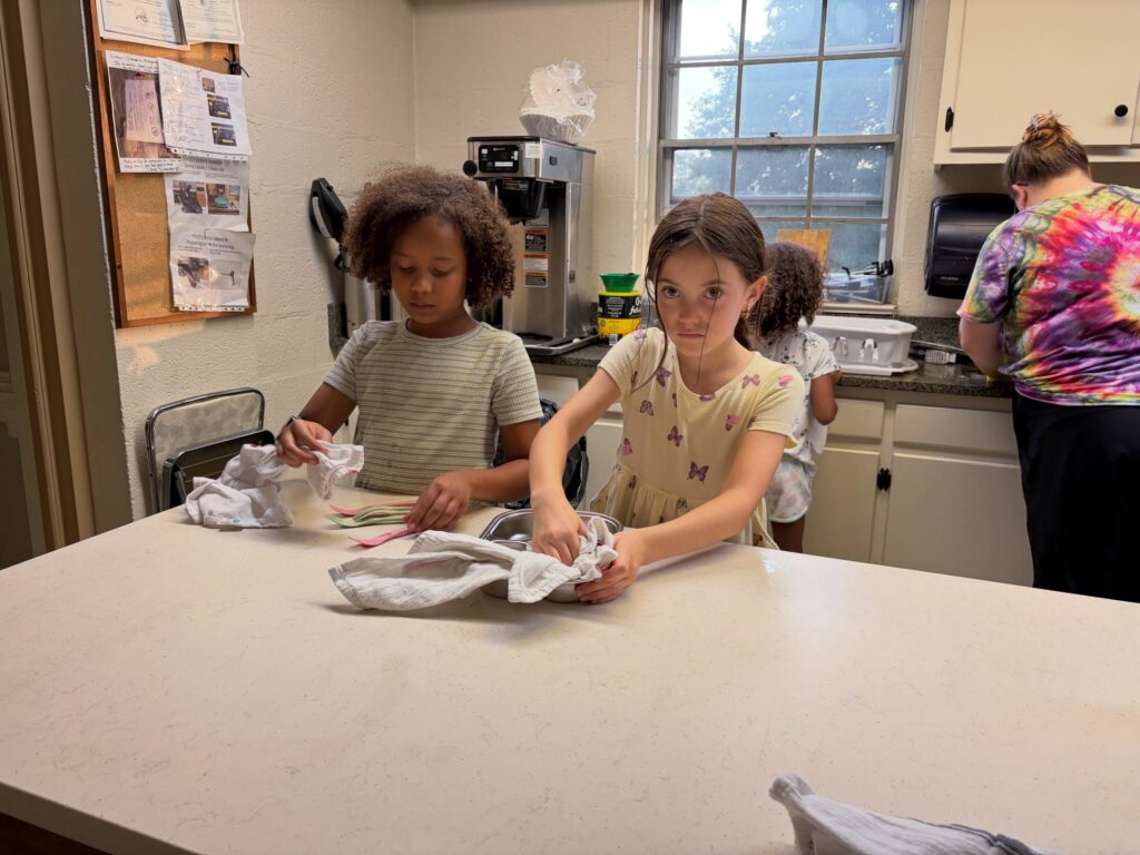Kids helping dry dishes
